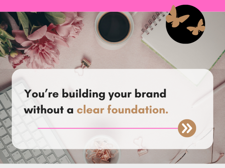 Flat lay workspace with pink flowers, a coffee cup, keyboard, notebook, and stationery on a soft neutral background. Overlaid text reads: “You’re building your brand without a clear foundation.” A pink line and arrow button appear beneath the text.